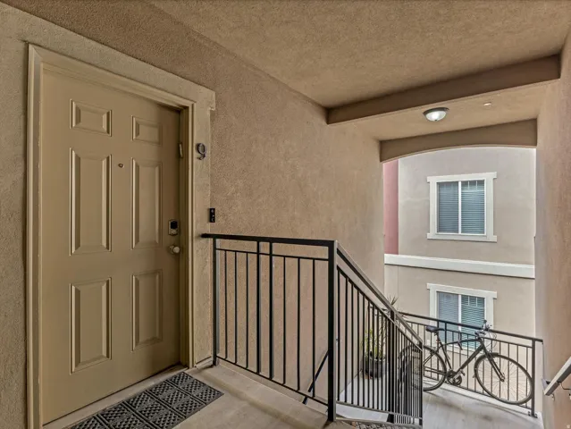 Entryway featuring a panel door with smart lock hardware