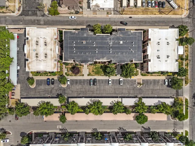 Aerial overview of a multi-building complex featuring extensive paved parking areas