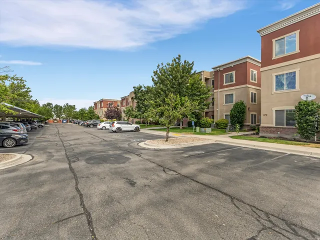 Multi-story stucco buildings featuring contrasting trim and brick accents