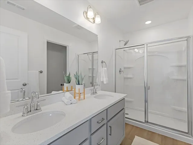 Dual vanity with white solid surface countertop featuring integrated sinks and polished chrome fixtures