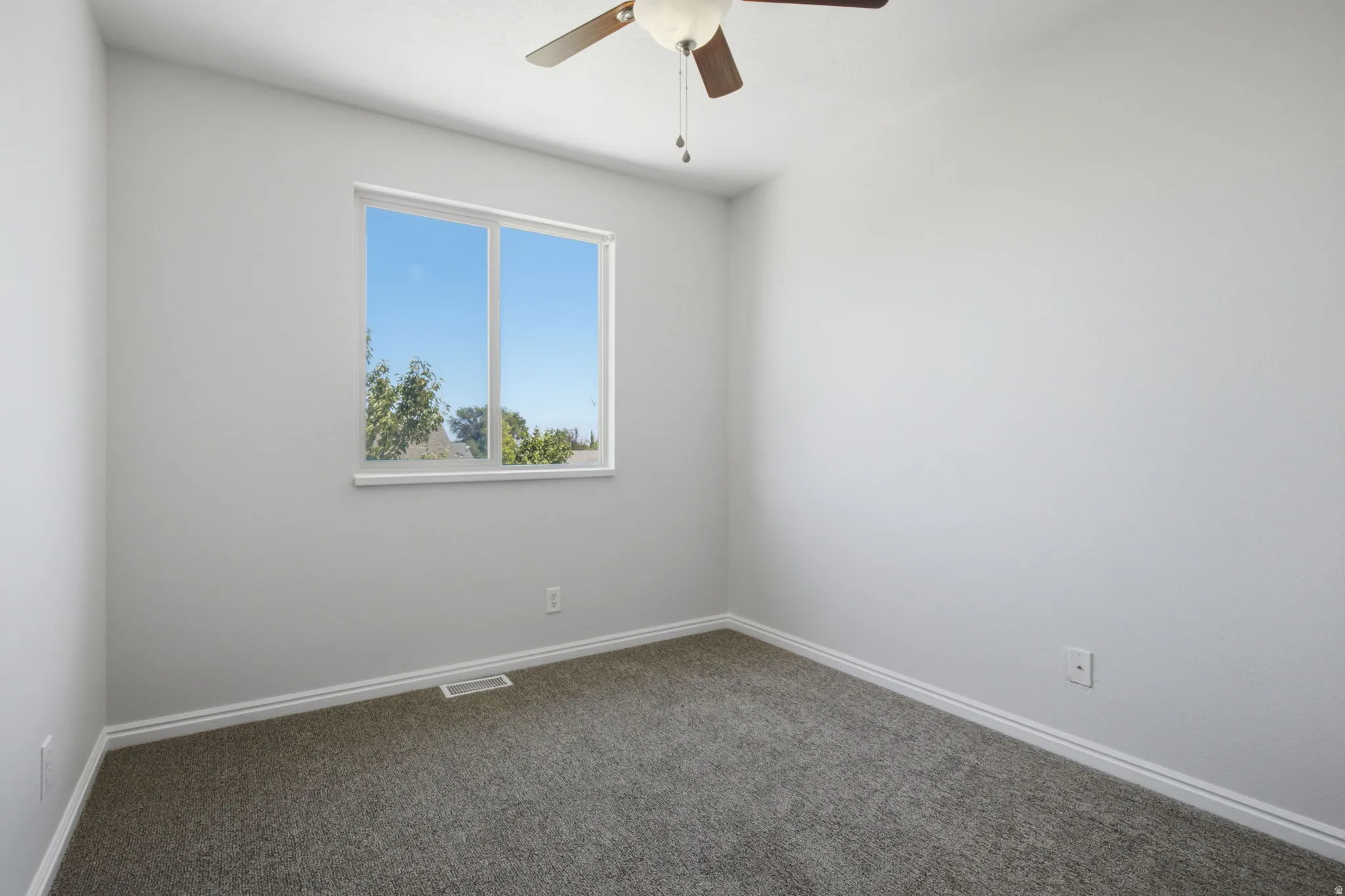 Neutral tone walls with an expansive window offering natural illumination