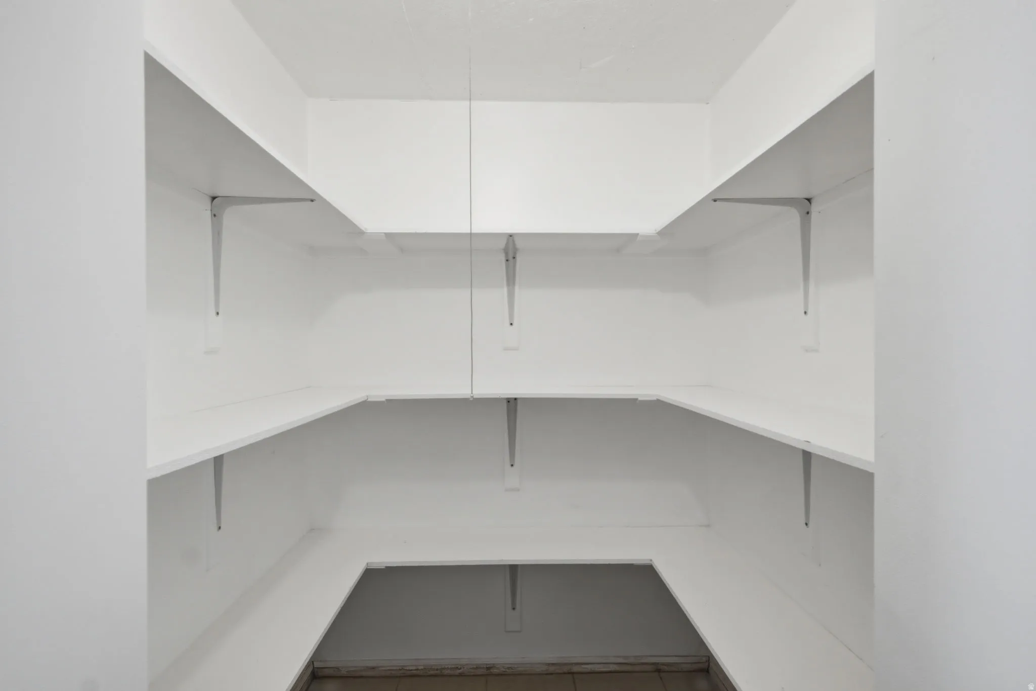 White shelving system with metal brackets