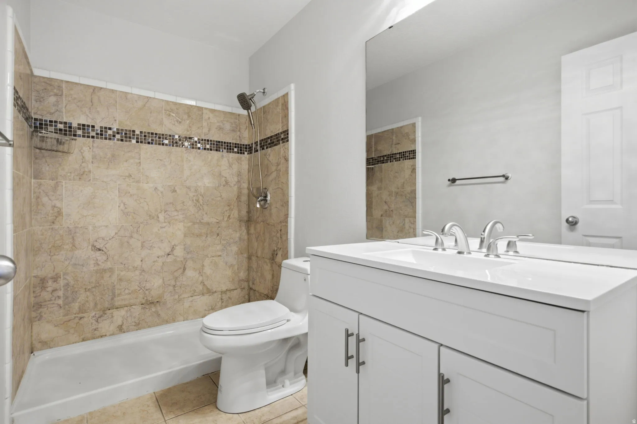 Bathroom vanity with dual sinks, white cabinetry, and polished chrome fixtures