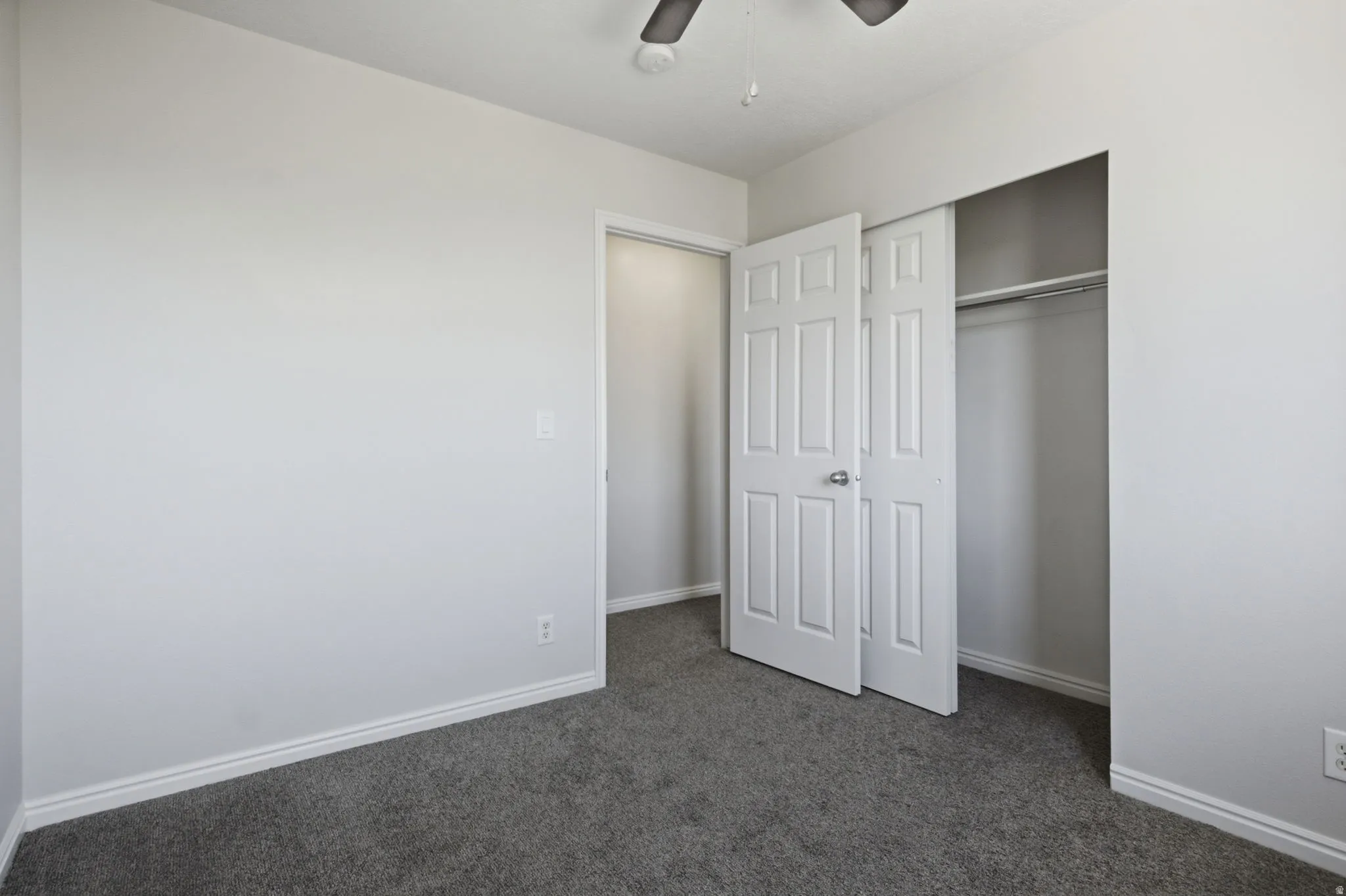 Bedroom with gray carpeting and light gray walls