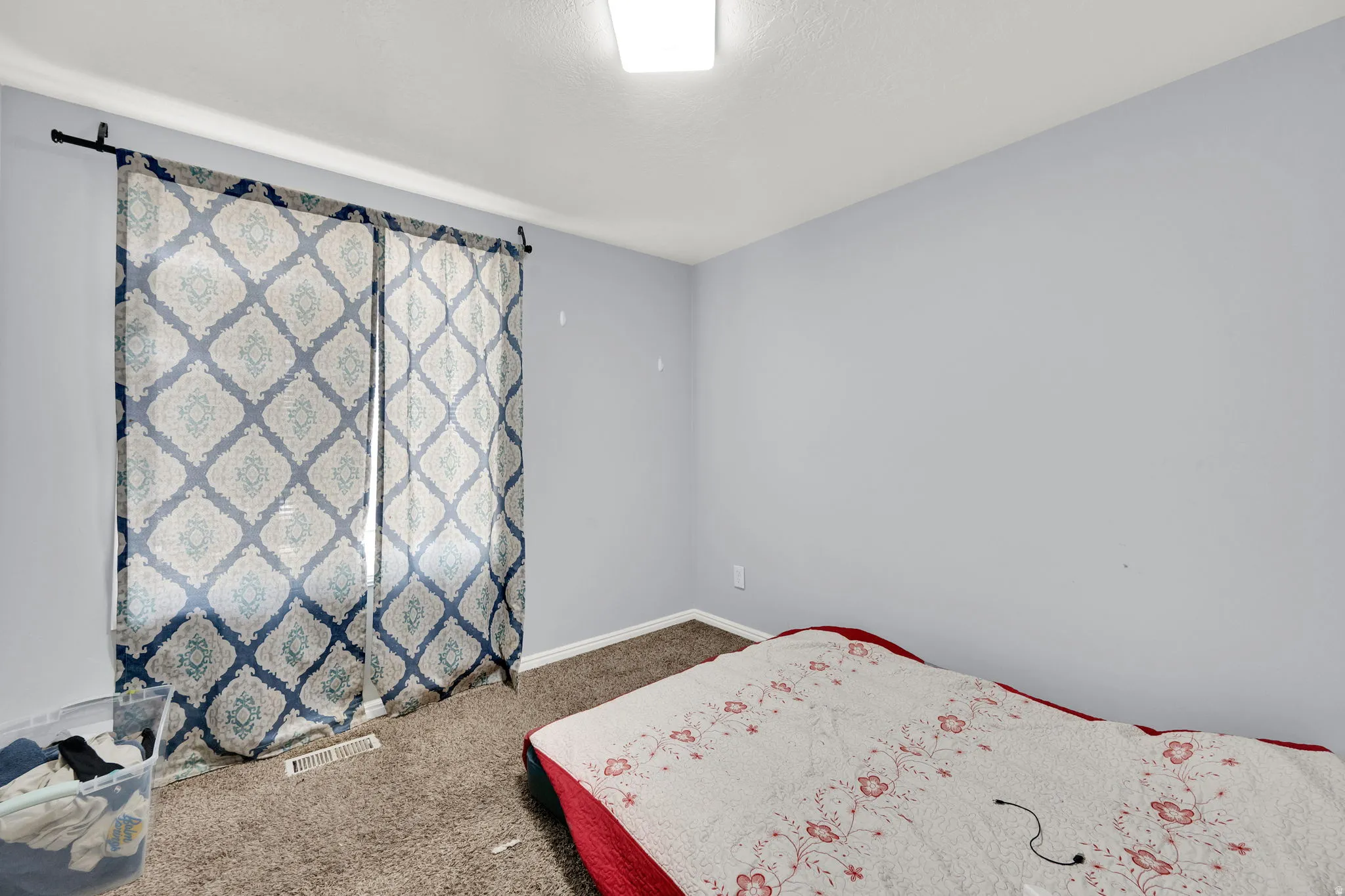 Room featuring light blue walls and brown carpet flooring