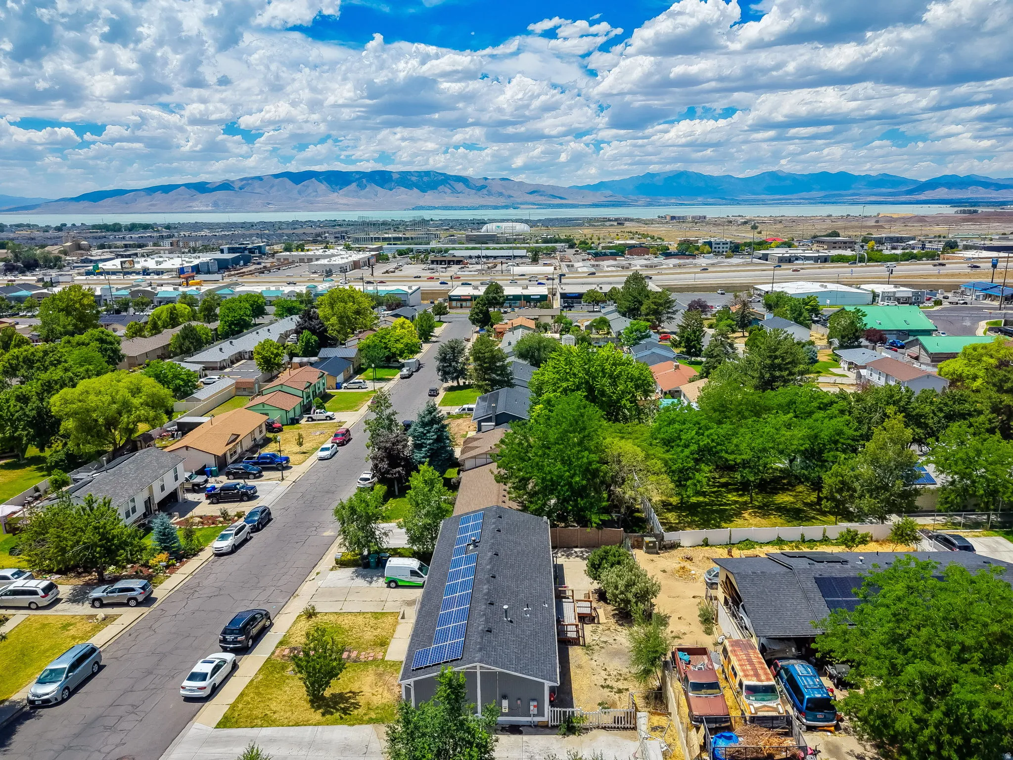 Aerial perspective showcasing a residential street with mature trees and established properties