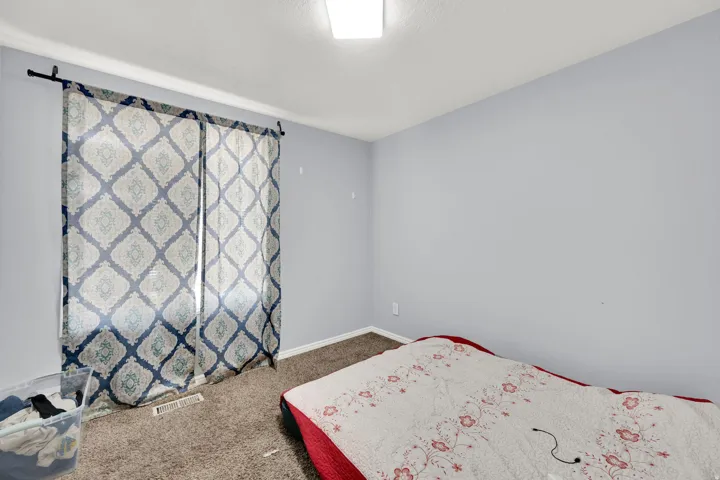 Room featuring light blue walls and brown carpet flooring