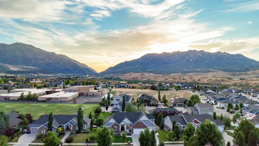 Residential community with diverse architectural styles, surrounded by mountainous terrain and established landscaping