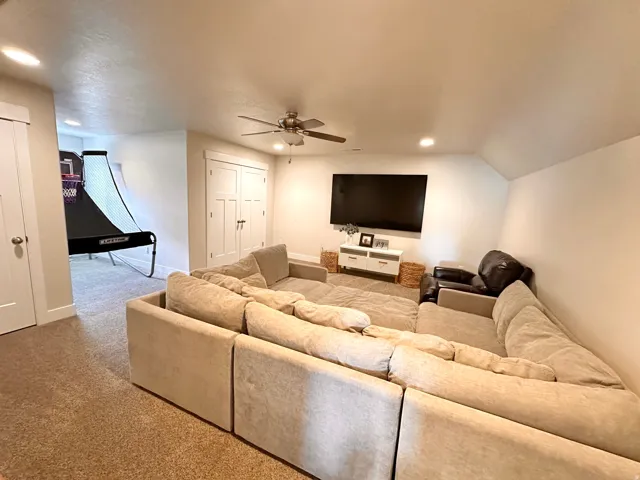 Entertainment space featuring recessed lighting, a ceiling fan, and carpet flooring