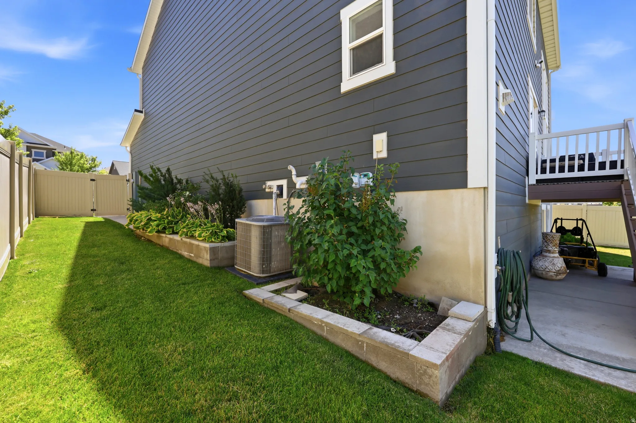Exterior siding in a dark gray horizontal paneling finish with white trim