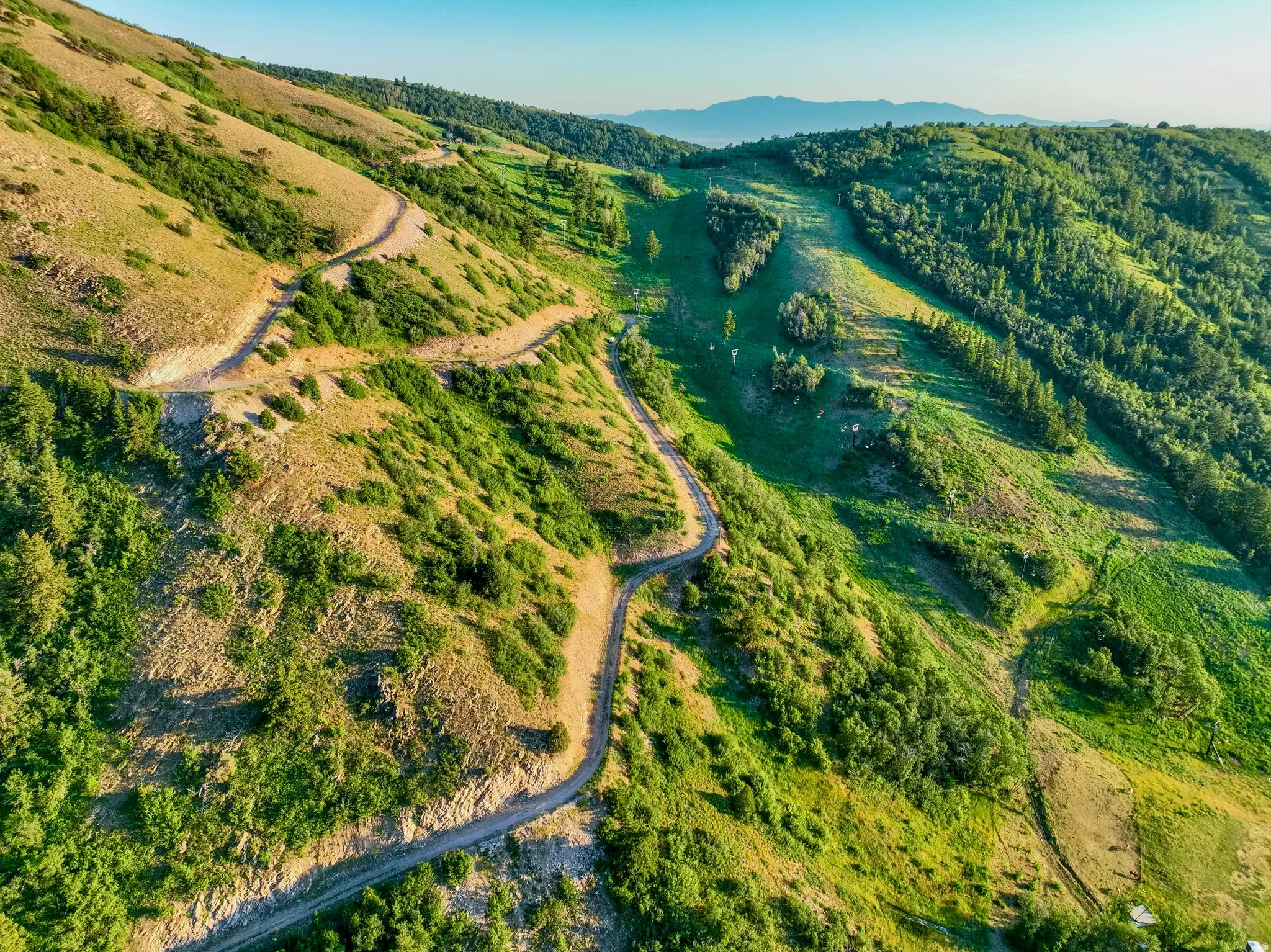 Expansive mountain terrain featuring natural landscaping and winding trails
