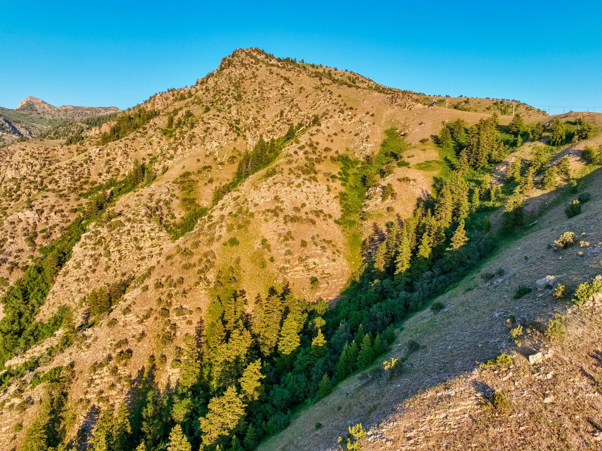 Mountainous terrain with varied elevations and natural vegetation
