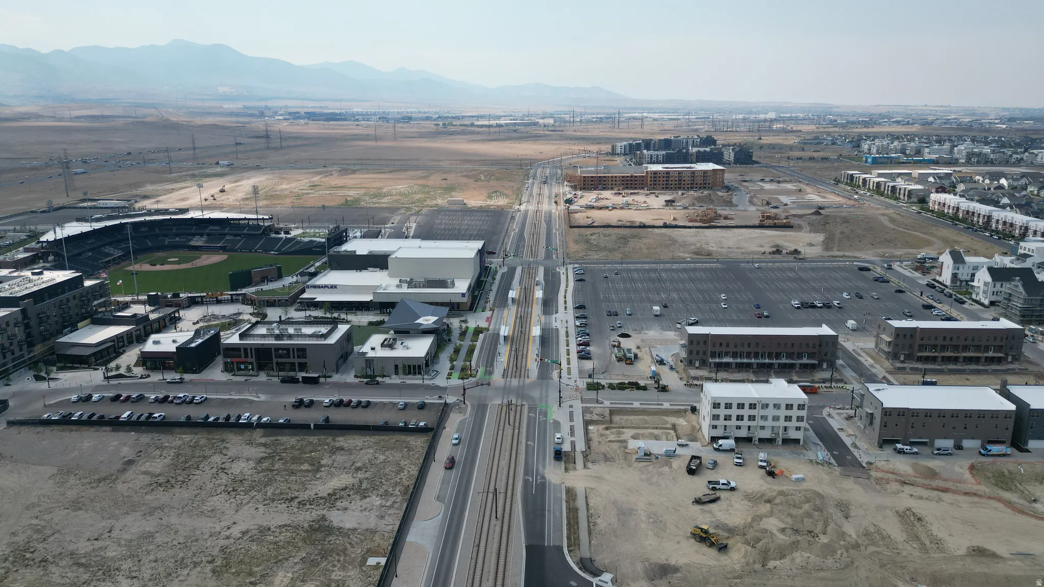 Expansive aerial overview showcasing a developing urban landscape with diverse commercial and residential structures