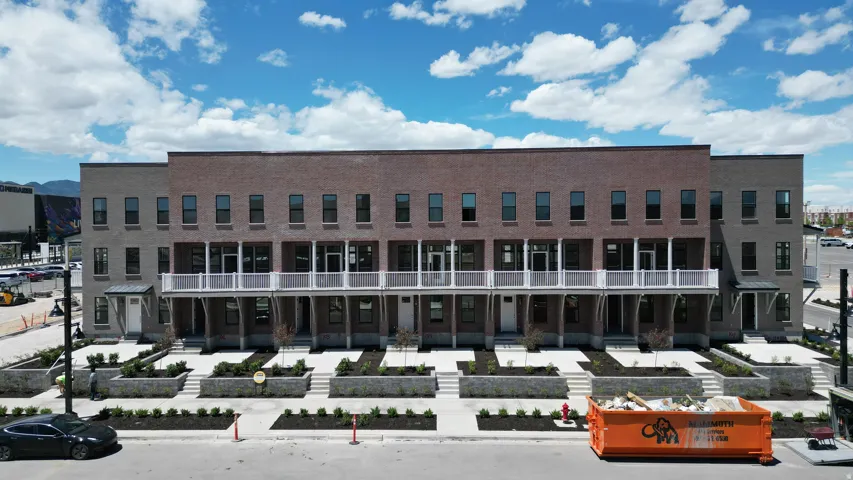 Contemporary townhome-style residences featuring brick and stone exteriors