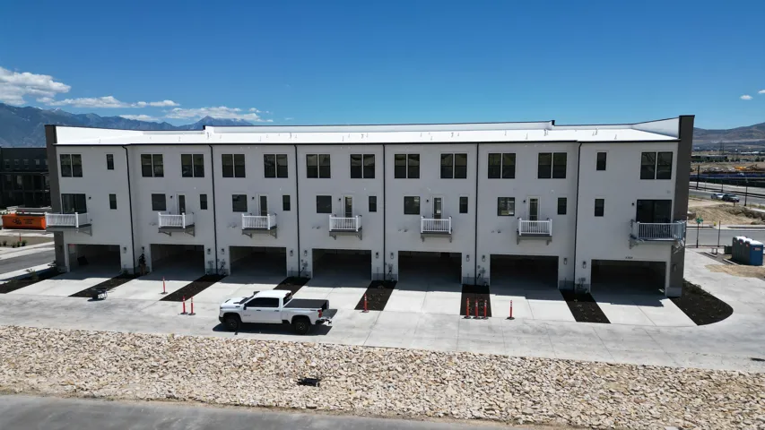 Contemporary townhome exteriors featuring white stucco and dark trim
