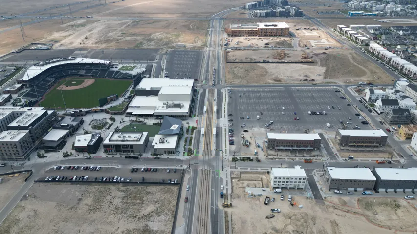 Aerial overview showcasing a baseball stadium with surrounding commercial and residential developments