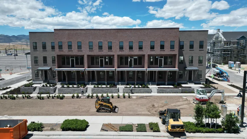 Multi-level townhome-style residences featuring brick and siding exteriors