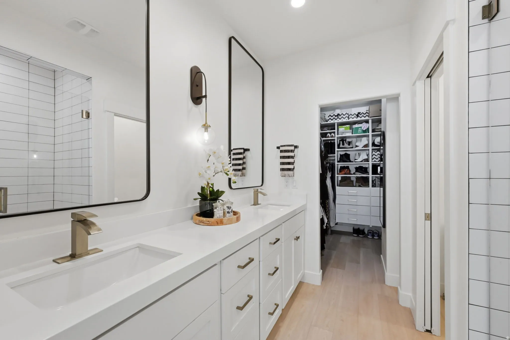 Ensuite bath with dual vanity with undermount sinks, quartz countertop, and brushed nickel fixtures