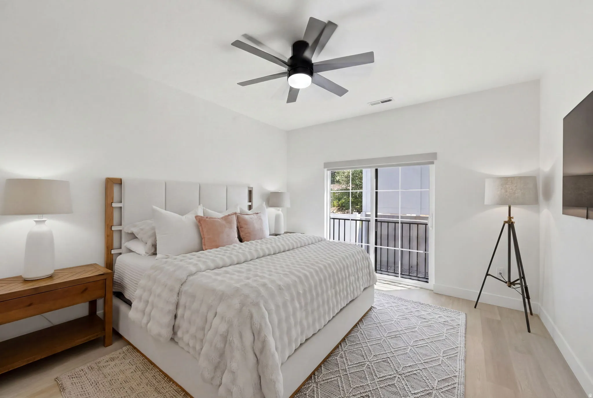 Bedroom featuring a modern ceiling fan, and sliding glass doors