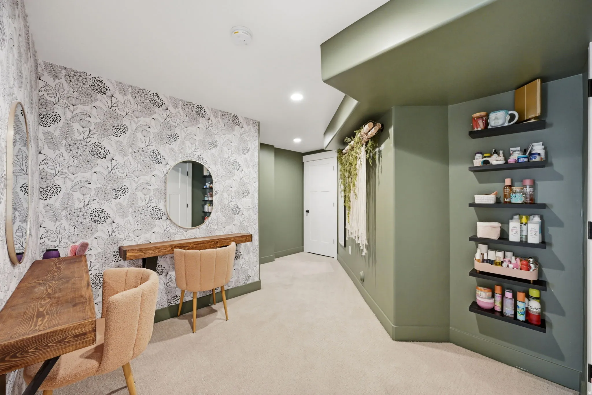 Accent wall featuring botanical pattern wallpaper and built in desks/vanities