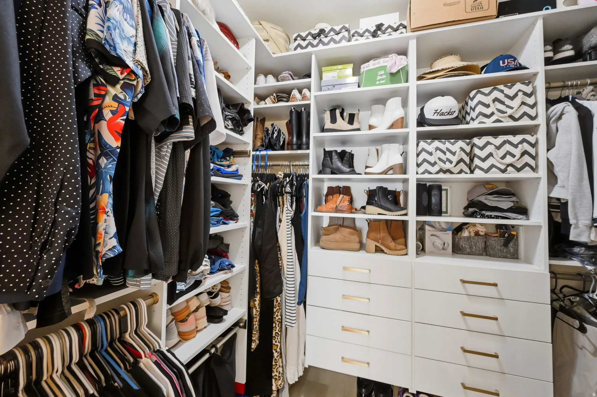 Walk in closet with organizers.