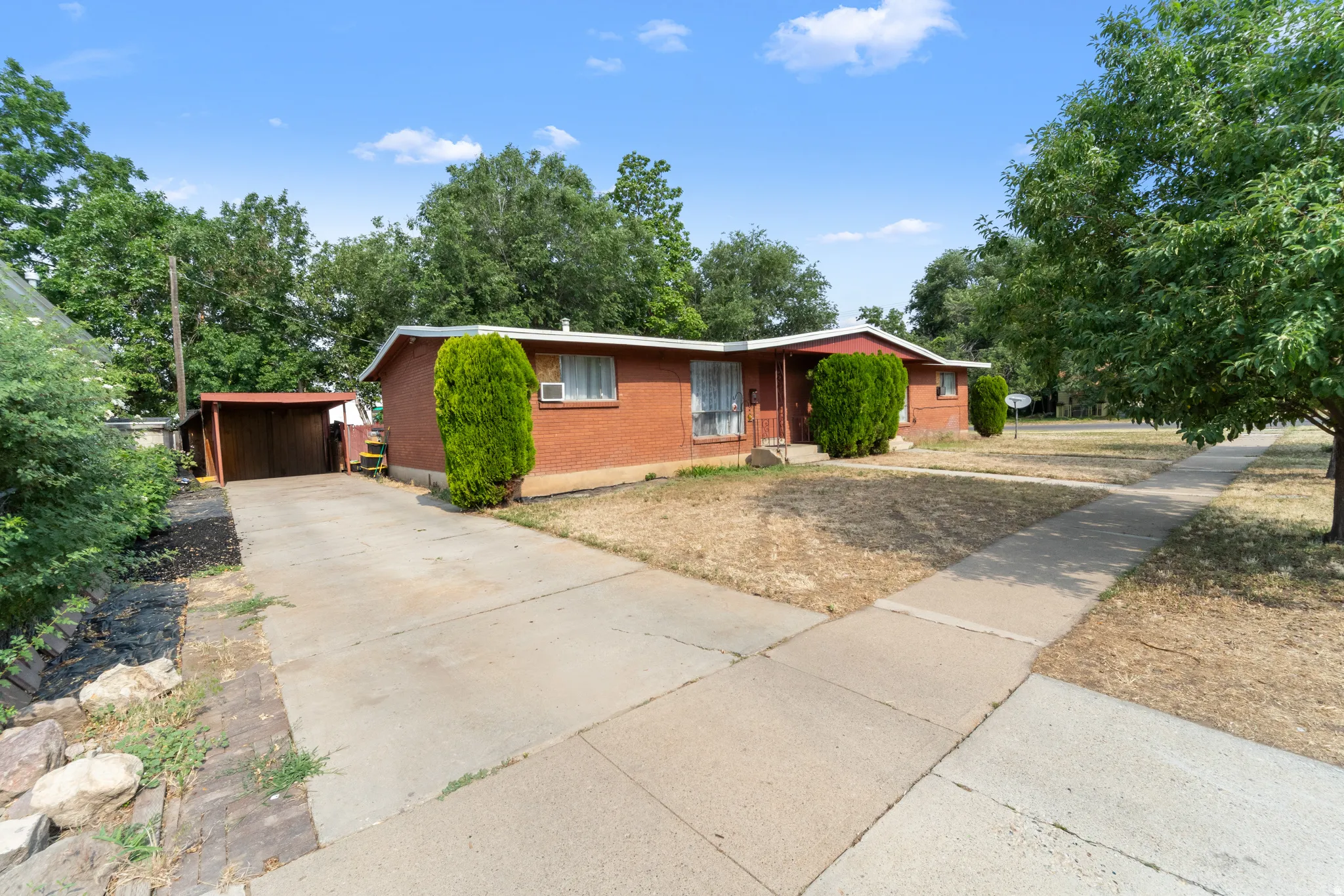 Brick exterior with a covered carport