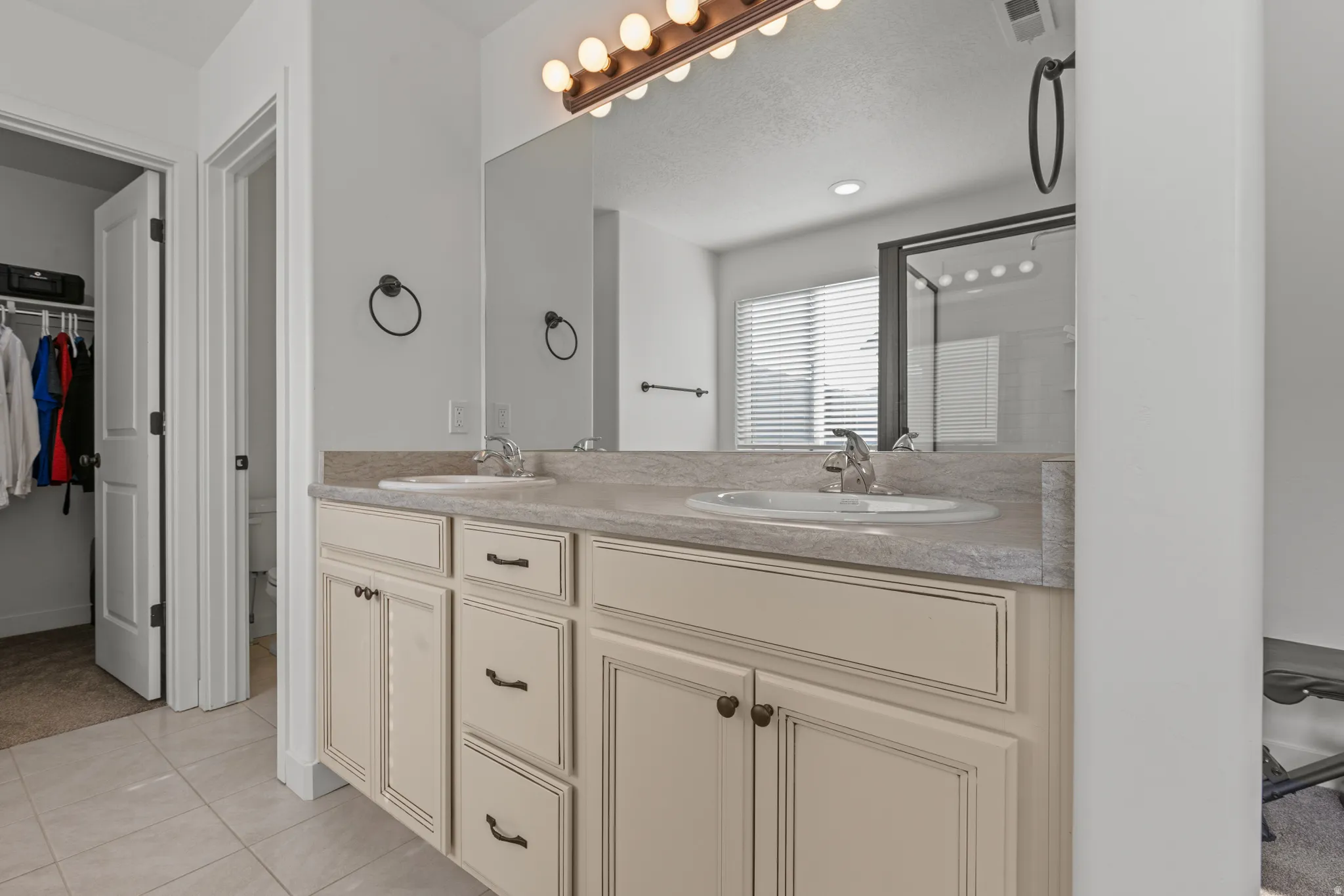 Double vanity with undermount sinks and light-toned cabinetry