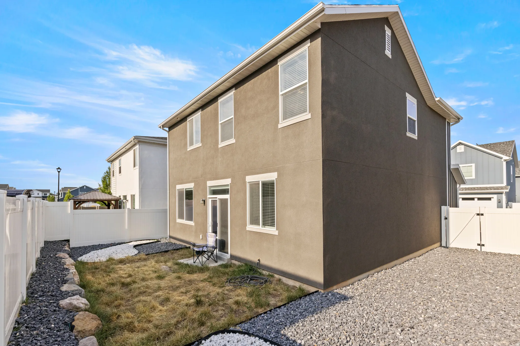 Two-story residence featuring stucco siding and white trim