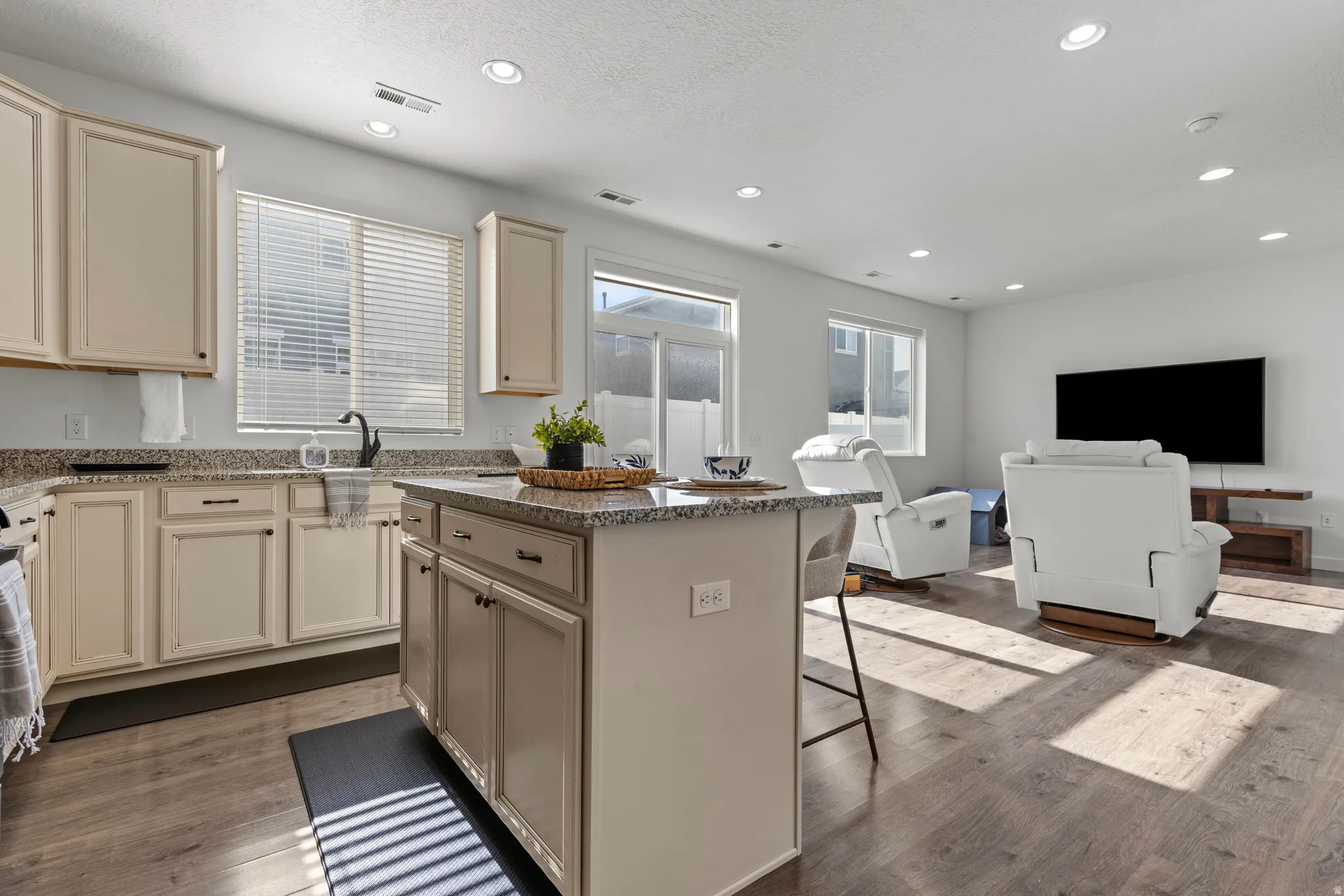 Open-concept living space featuring wood-finish flooring