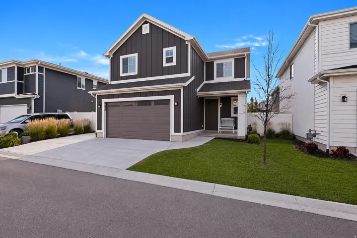 Modern two-story residence featuring dark vertical siding and white trim