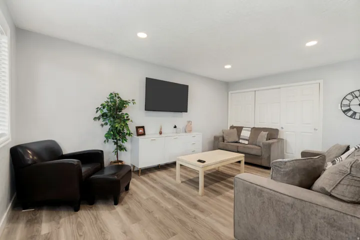 Living area featuring wood-finish flooring, recessed lighting, and light gray wall tones