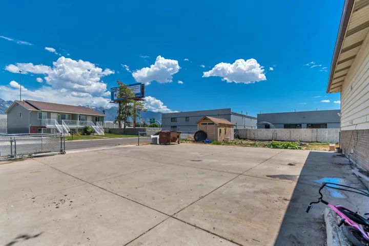 Expansive paved concrete lot with a chain-link fence
