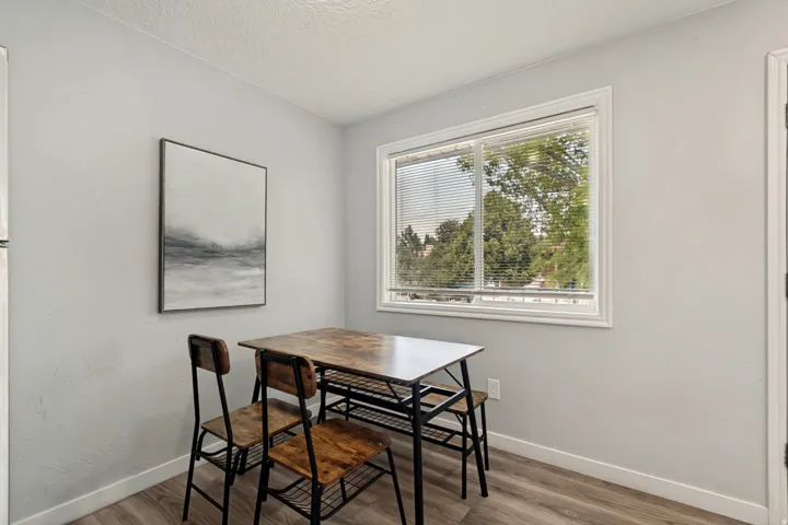 Dining area with a large window and wood-finish flooring