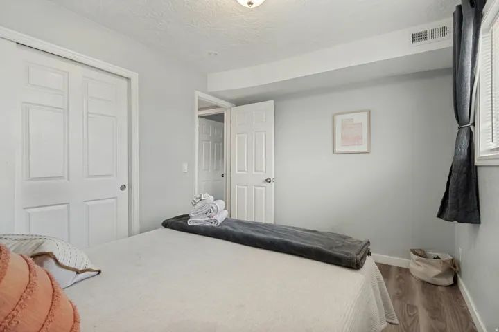 Light gray walls complement the wood-finish flooring in this room