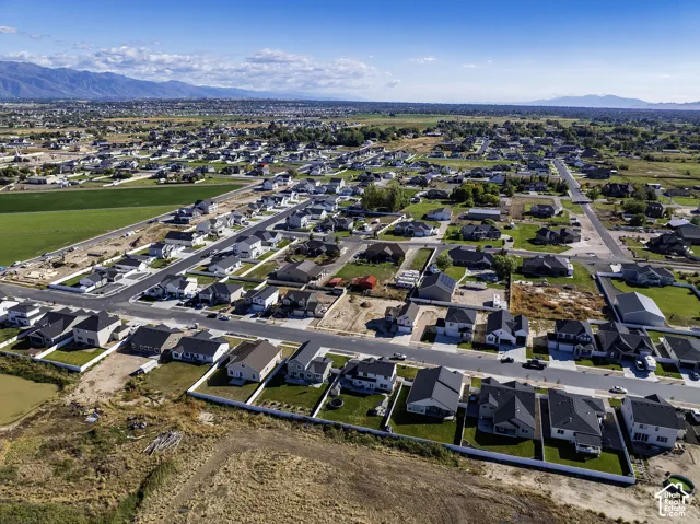 Aerial perspective of a developed residential area featuring various single-family homes with distinct architectural styles
