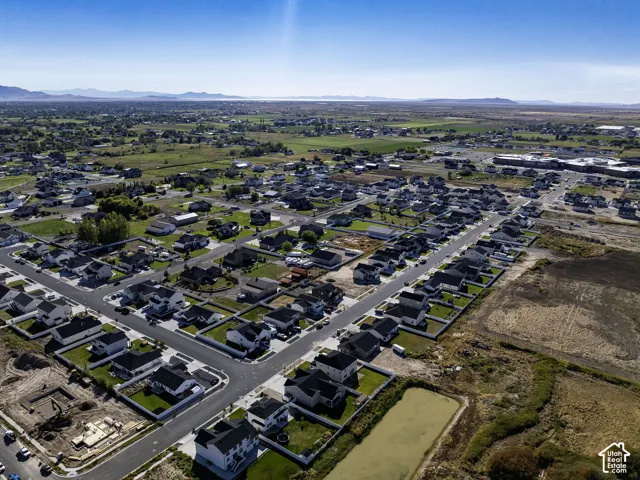 Expansive neighborhood setting with established residential streets, mature landscaping, and surrounding undeveloped land