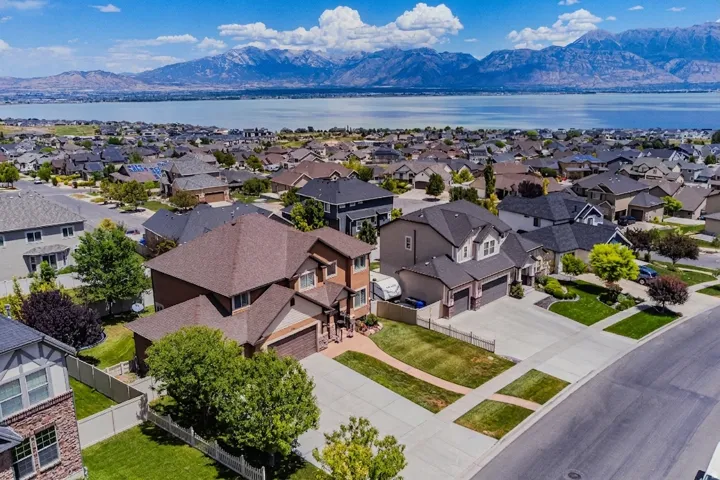 Expansive residential community with established homes, mature landscaping, and mountain-bordered lake scenery