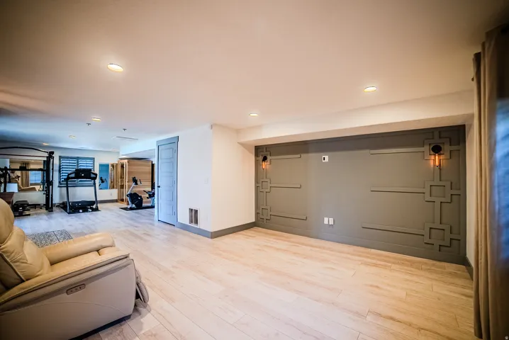 Expansive lower-level space featuring recessed lighting and light wood-finish flooring