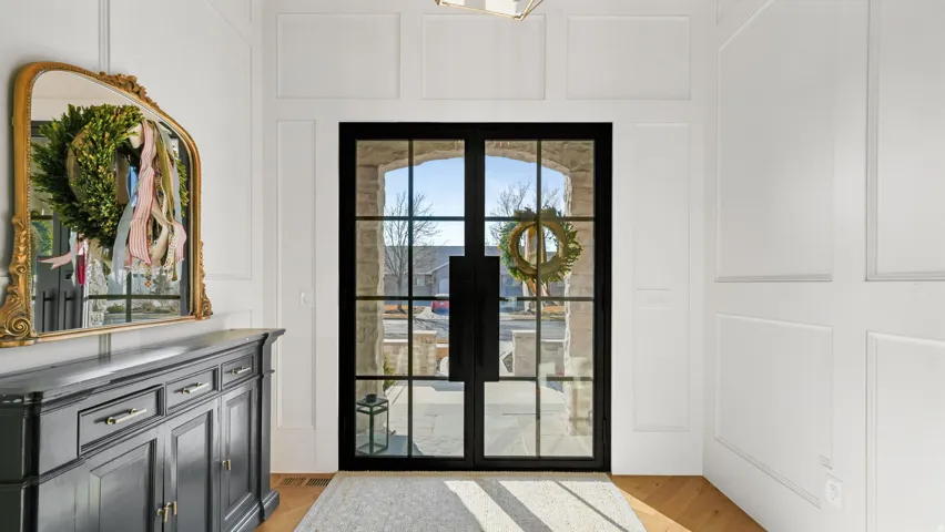 Gridded glass double entry doors set within a stone archway