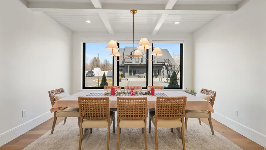 Dining area featuring a coffered ceiling, recessed lighting, and wood-finish flooring
