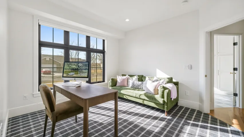 Room with high ceilings and a large multi-pane window