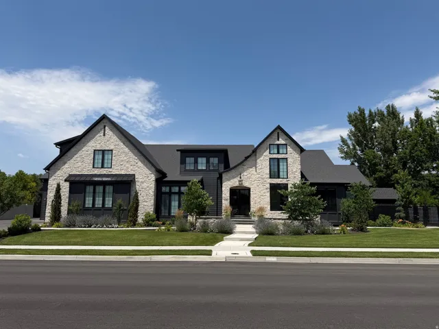 Stone and dark-toned siding exterior with multiple gables