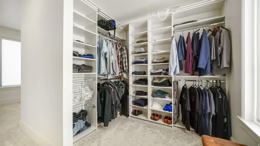 Custom closet system featuring extensive shelving, multiple hanging rods, and wire basket drawers