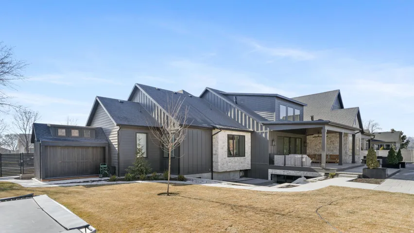 Modern exterior featuring grey siding and multiple rooflines