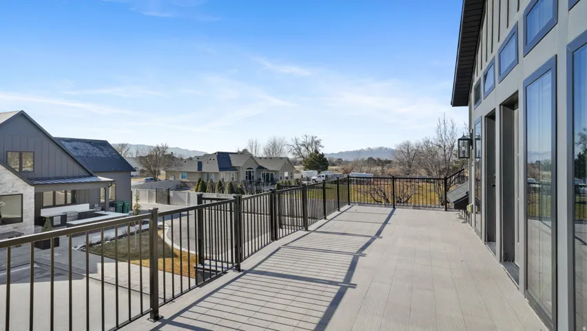 Expansive outdoor deck featuring composite decking and a black metal railing