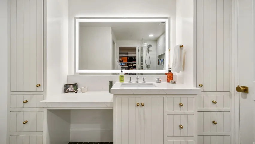 Built-in vanity with integrated sink and chrome fixtures