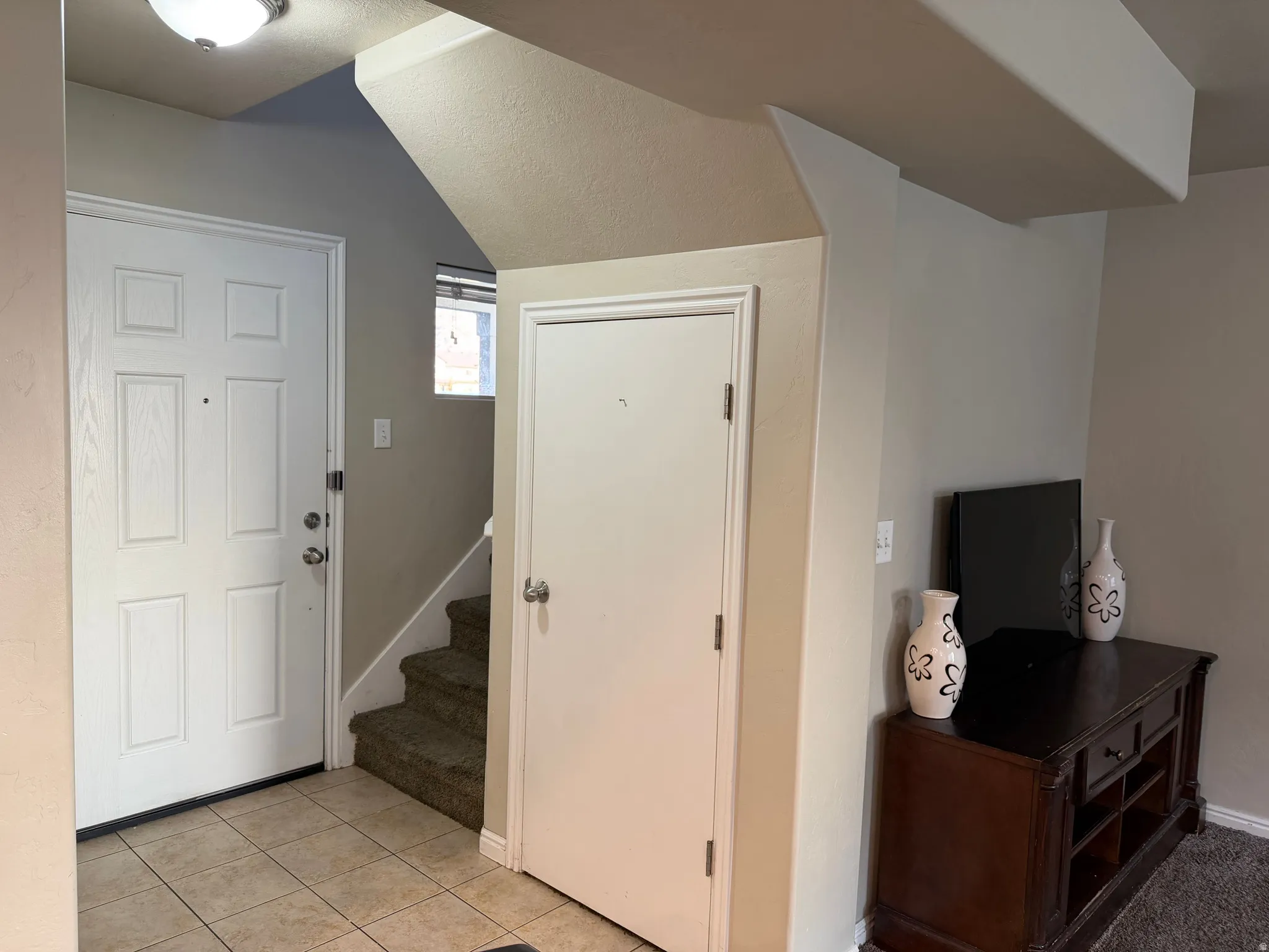 Entry foyer featuring tile flooring