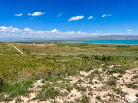 Expansive natural landscape featuring rolling hills and distant mountains