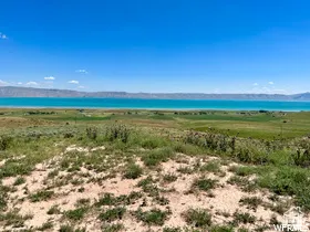 Expansive natural landscape with a turquoise body of water in the background