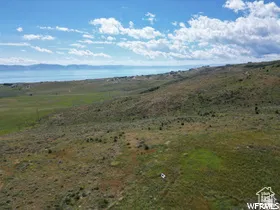 Expansive undeveloped land featuring rolling hills and distant water